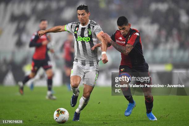 Cristiano Ronaldo of Juventus fights for the ball with Cristian Romero of Genoa CFC during the Serie A match between Juventus and Genoa CFC at...
