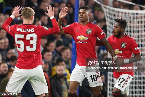 Marcus Rashford of Man Utd celebrates scoring the opening goal from the penalty spot with Brandon Williams and Fred during the Carabao Cup Round of...