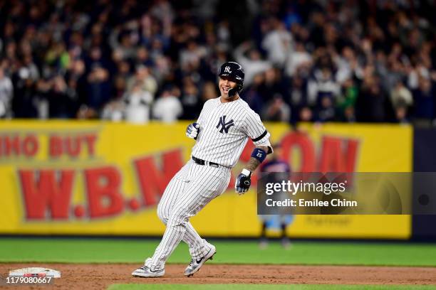 Gleyber Torres of the New York Yankees celebrates after hitting an RBI double to score Aaron Judge and Brett Gardner against Tyler Duffey of the...