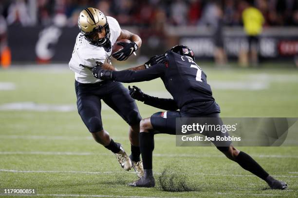 Gabriel Davis of the Central Florida Knights tries to break a tackle against Coby Bryant of the Cincinnati Bearcats in the second quarter at Nippert...