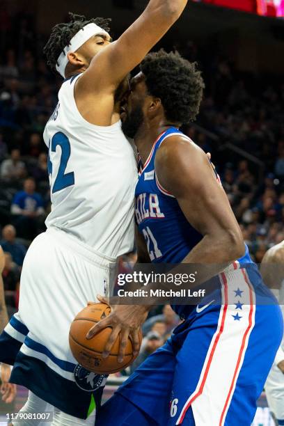 Joel Embiid of the Philadelphia 76ers drives to the basket against Karl-Anthony Towns of the Minnesota Timberwolves in the first quarter at the Wells...