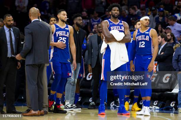 Ben Simmons, Joel Embiid, and Tobias Harris of the Philadelphia 76ers look on after Joel Embiid got into a fight with Karl-Anthony Towns of the...