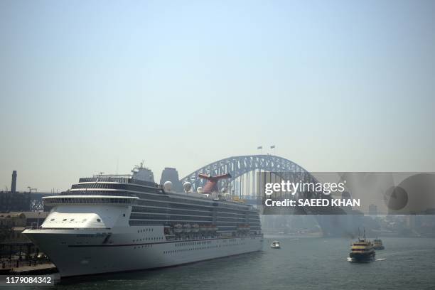 Smoke from rural bushfires are seen over Sydney Harbour on October 31, 2019. - Sydney residents coughed and spluttered their way around Australia's...