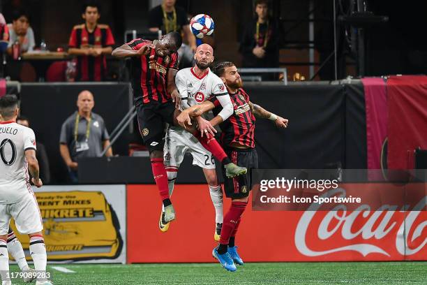 Toronto's Laurent Ciman battles for a header between Atlanta's Florentin Pogba and Leandro González Pirez during the MLS playoff match between...
