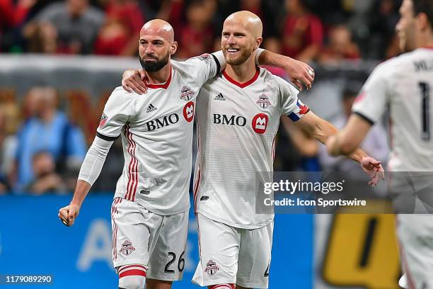 Toronto's Laurent Ciman and Michael Bradley celebrate Toronto's victory following the conclusion of the MLS playoff match between Toronto FC and...