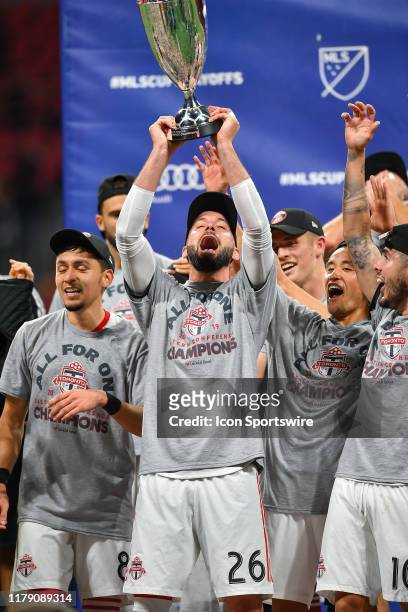 Toronto's Laurent Ciman celebrates with the MLS Eastern Conference trophy following the conclusion of the MLS playoff match between Toronto FC and...