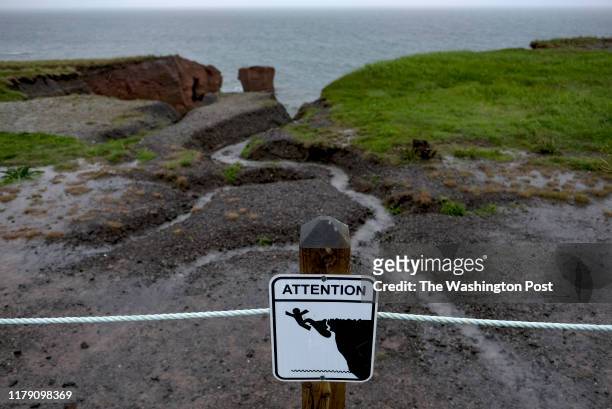 Sign warns about the danger of erosion in Magdalen Islands, Quebec on June 21, 2019. The islands are warming at about twice the global average. Once...