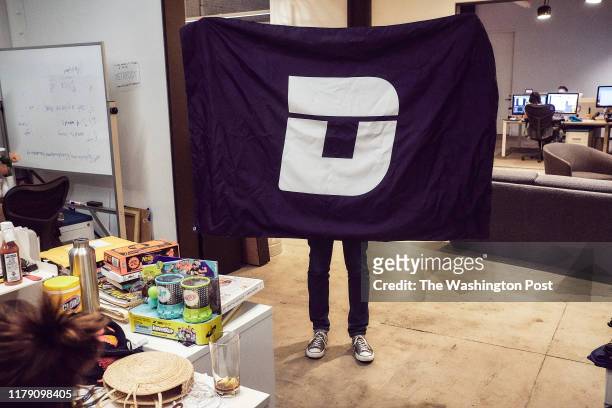 An employee of the website Deadspin shows a logo at their office in Manhattan, New York on November 1, 2018.