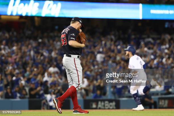 Sean Doolittle of the Washington Nationals reacts after giving up a solo home run to Max Muncy of the Los Angeles Dodgers in the seventh inning in...