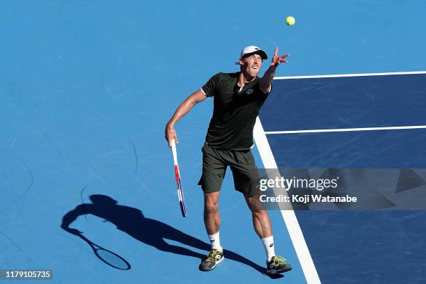 John Millman of Australia severs shot during his match against Reilly Opelka of the United States on day six of the Rakuten Open at the Ariake...