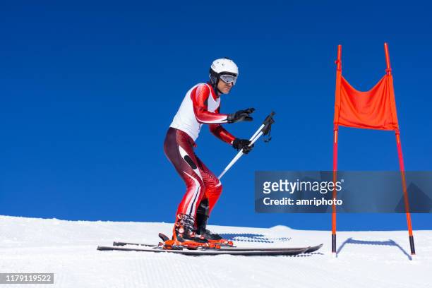 concentrated professional skier during race inspection clear blue sky - racing suit stock pictures, royalty-free photos & images