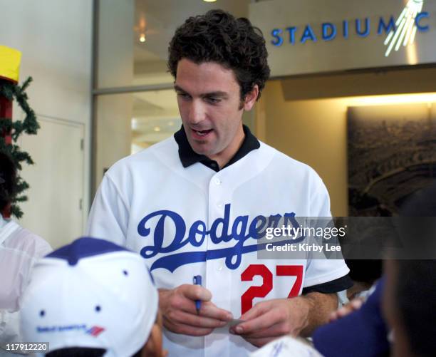 Los Angeles Dodgers pitcher D.J. Houlton signs autographs for children at the team's annual children's holiday party at Dodger Stadium in Los...