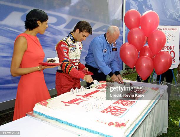 Actress/Model Drena De Niro watches as Winston Cup driver Jeff Gordon and Apollo 15 Astronaut Al Worden cut the huge DuPont Anniversary cake