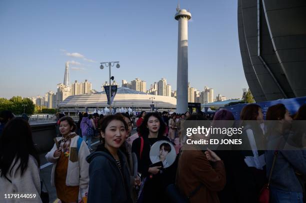 In a photo taken on October 29 fans of South Korea's BTS K-pop group arrive for the final concert of their world tour at the Olympic stadium in...