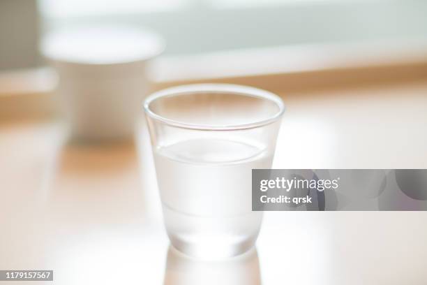 water glass on a table - sugar in glass stock pictures, royalty-free photos & images