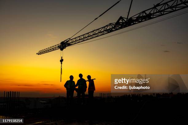 developing the city for the better together - construction site and silhouette stock pictures, royalty-free photos & images