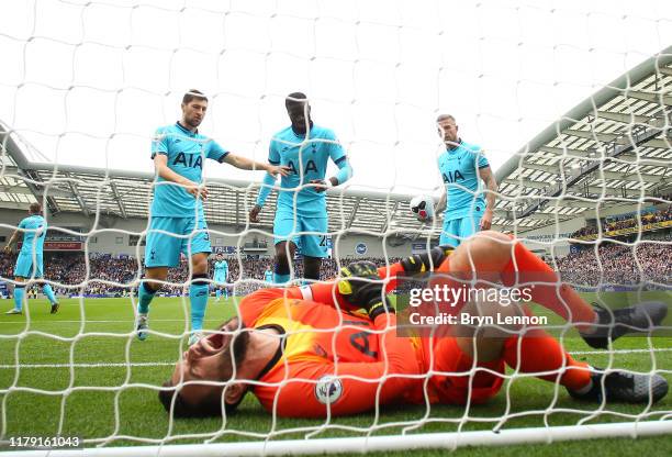 Hugo Lloris of Tottenham Hotspur goes down injured during the Premier League match between Brighton & Hove Albion and Tottenham Hotspur at American...