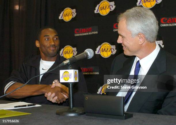 Los Angeles Lakers Kobe Bryant shakes hands with general manager Mitch Kupchak looks during a news conference Thursday, July 15 at the team's...