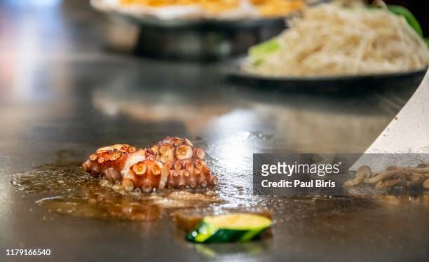 chef cooking grilled octopus in japanese teppanyaki restaurant, kobe, japan - teppanyaki stock pictures, royalty-free photos & images