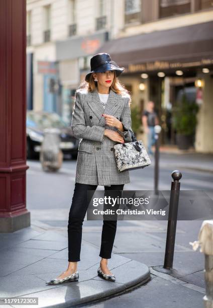 Alexandra Lapp is seen wearing Teddy D small brim bucket hat in leather, J’adior ballet-flat in tartan fabric Dior, saddle belt clutch in black...