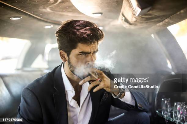 smoking a cigar - cigar smokers stock pictures, royalty-free photos & images
