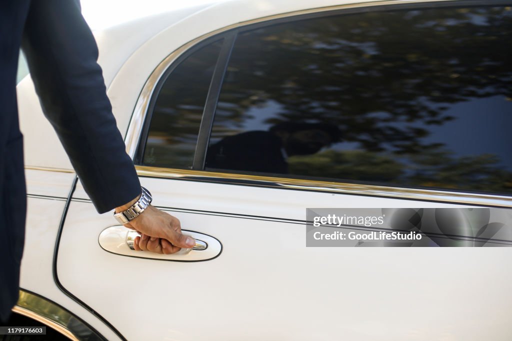 Opening a limousine door