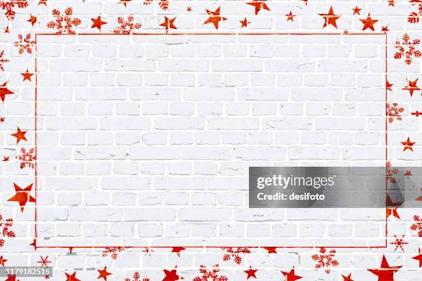 vector illustration of a christmas theme photo or picture frame in bright red coloured elements snowflakes , stars, surrounding/ making a border of a grunge textured brick wall - pentagram stock illustrations