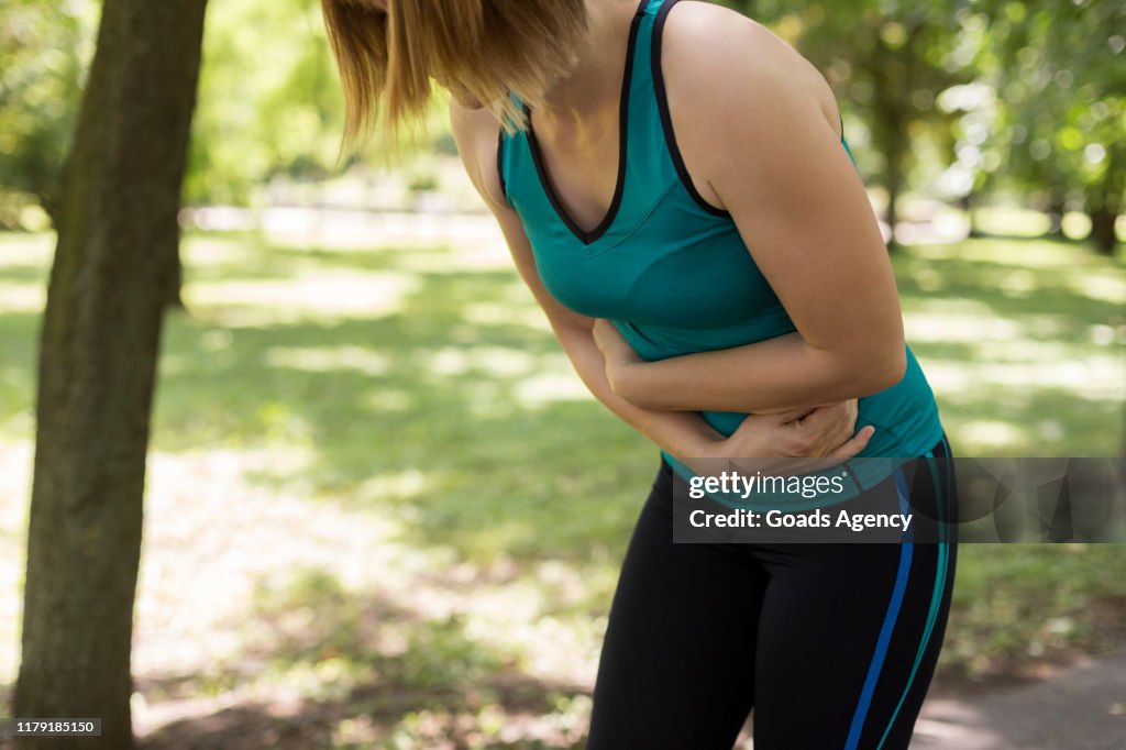 Fit woman having stomachache