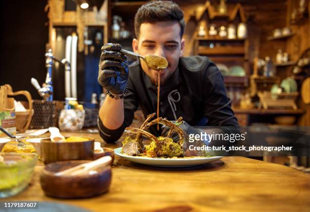 master chef he's pouring sauce over dinner - pouring sauce stock pictures, royalty-free photos & images