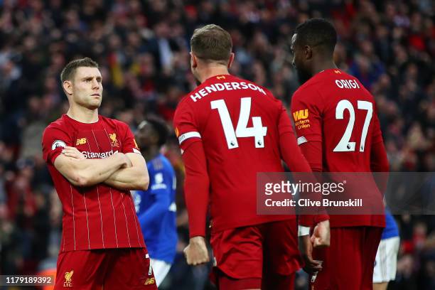 James Milner of Liverpool celebrates with Jordan Henderson of Liverpool and Divock Origi of Liverpool after he scores his sides second goal from the...