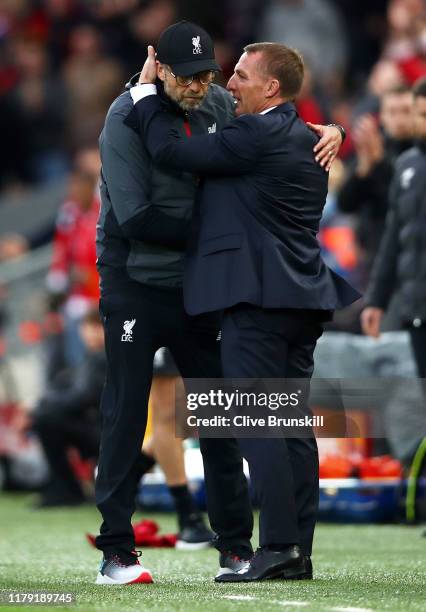 Jurgen Klopp, Manager of Liverpool embraces Brendan Rodgers, Manager of Leicester City after the Premier League match between Liverpool FC and...