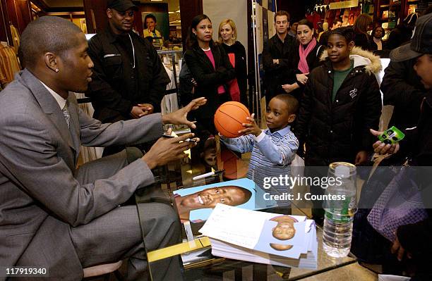 Jamal Crawford signs autographs for fans during Perry Ellis and Travel & Leisure Magazine Host In-Store Appearance by NBA Star Jamal Crawford at...