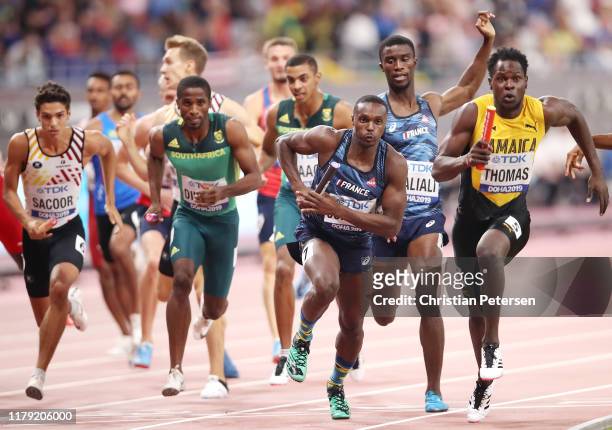 Terry Ricardo Thomas of Jamaica and Thomas Jordier of France compete in the Men's 4x400 metres relay heats during day nine of 17th IAAF World...