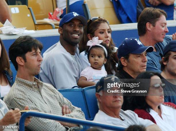 Kobe Bryant sits with his daughter and wife Vanessa during the Los Angeles Dodgers contest against the New York Yankees at Dodger Stadium, June 20,...