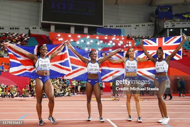 Asha Philip, Dina Asher-Smith, Ashleigh Nelson and Daryll Neita of Great Britain celebrate silver in the Women's 4x100 Metres Relay during day nine...