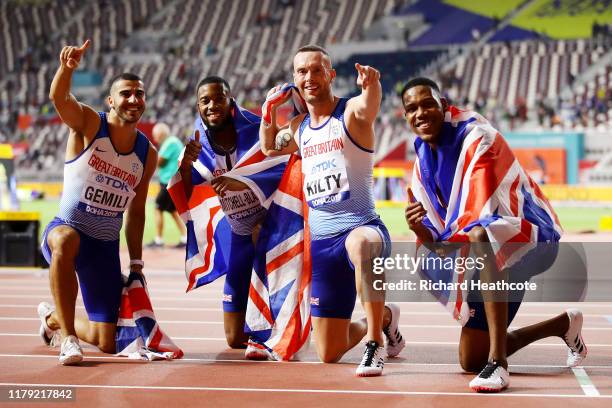 Adam Gemili, Zharnel Hughes, Richard Kilty and Nethaneel Mitchell-Blake of Great Britain celebrate silver in the Men's 4x100 Metres Relay during day...