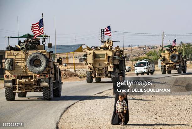 Convoy of US armoured vehicles patrols the northeastern town of Qahtaniyah at the border with Turkey, on October 31, 2019. - US forces accompanied by...