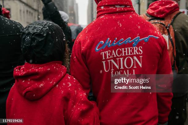Braving snow and cold temperatures, thousands marched through the streets near City Hall during the 11th day of an ongoing teachers strike on October...