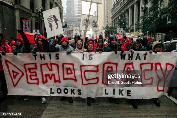 Braving snow and cold temperatures, thousands marched through the streets near City Hall during the 11th day of an ongoing teachers strike on October...