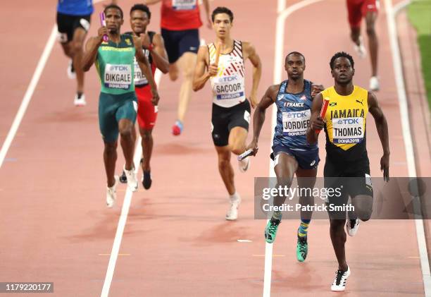 Terry Ricardo Thomas of Jamaica and Thomas Jordier of France compete in the Men's 4x400 metres relay heats during day nine of 17th IAAF World...