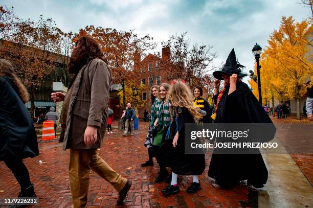 Harry Potter fans walk during Halloween on October 31, 2019 in Salem, Massachusetts. - Salem is a mecca for witches and fans of the occult,...