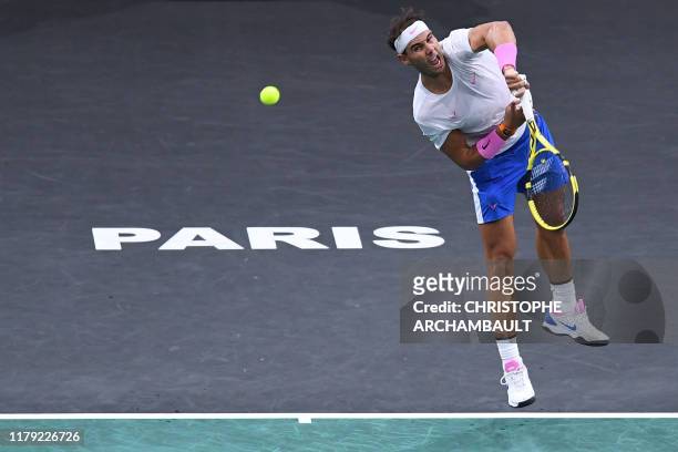 Spain's Rafael Nadal returns the ball to Switzerland's Stan Wawrinka during their men's singles tennis match on day four of the ATP World Tour...