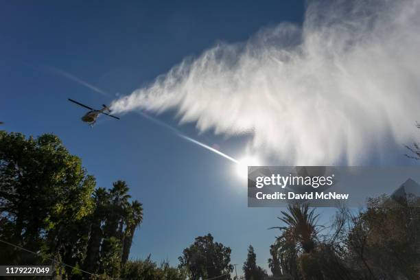 Firefighting helicopter makes a drop at the 46 Fire on October 31, 2019 near San Bernardino, California. The National Weather Service issued a rare...