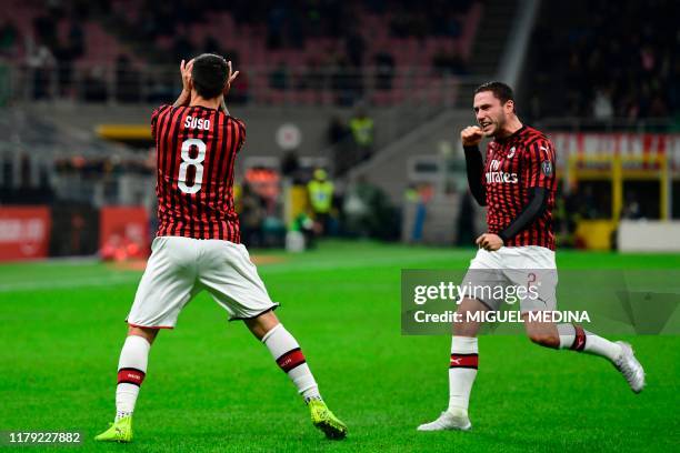 Milan's Spanish forward Suso celebrates scoring his team's first goal with AC Milan's Italian defender Davide Calabria during the Italian Serie A...