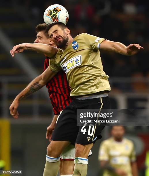 Nenad Tomovic of Spal competes for the ball with Krzysztof Piatek of AC Milan during the Serie A match between AC Milan and SPAL at Stadio Giuseppe...