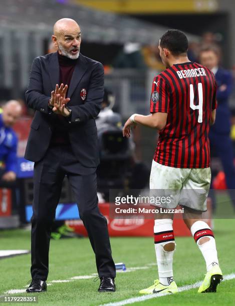 Milan coach Stefano Pioli issues instructions to his player Ismael Bennacer during the Serie A match between AC Milan and SPAL at Stadio Giuseppe...
