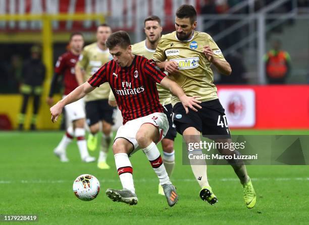 Krzysztof Piatek of AC Milan competes for the ball with Nenad Tomovic of Spal during the Serie A match between AC Milan and SPAL at Stadio Giuseppe...