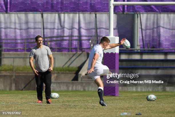 Former England player Jonny Wilkinson gives kicking advice to Owen Farrell during the England training session held at the Fuchu Assahi Football Park...