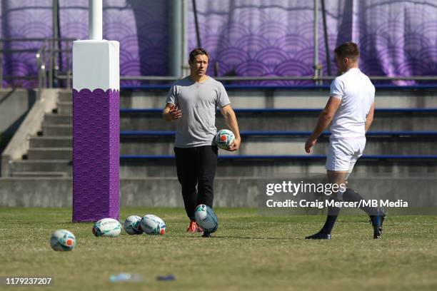 Former England player Jonny Wilkinson gives kicking advice to Owen Farrell during the England training session held at the Fuchu Assahi Football Park...