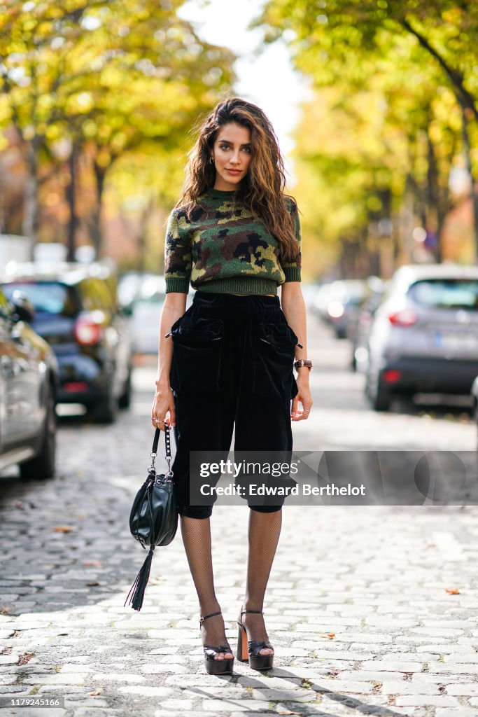 Jessica Kahawaty wears a military camouflage print pullover, black ...